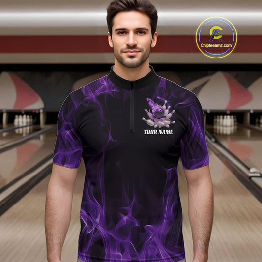 Male model at a bowling lane wearing a black and purple bowling quarter-zip shirt with bowling strike graphics and fiery accents.