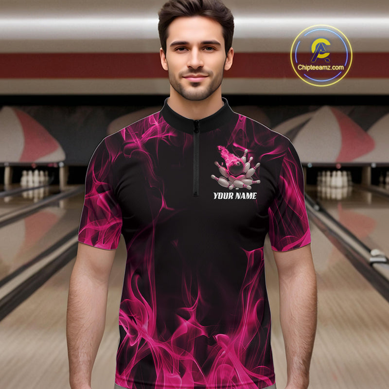 Male model wearing a black and pink bowling quarter-zip shirt at a bowling lane with bowling action artwork and fiery background details.