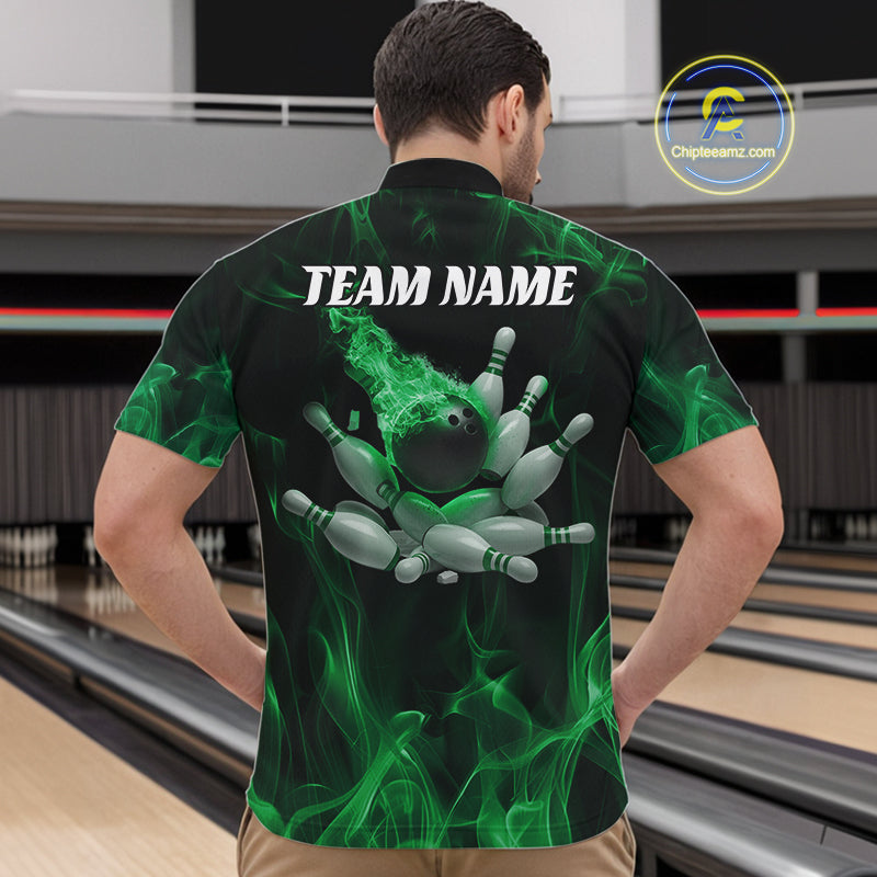Front view of a male model in a bowling center wearing a black and green quarter-zip shirt showcasing a bowling ball and scattered pin design.