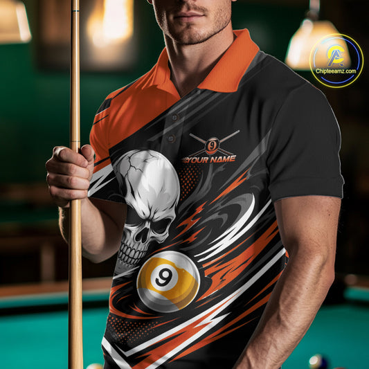 A man in a pool hall wearing a black and orange billiard polo shirt with a skull and billiard ball graphic, holding a pool cue. The shirt features a customizable design with a white skull, a yellow and black 9-ball