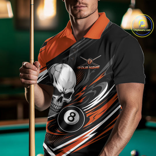 A man in a pool hall wearing a black and orange polo shirt with a skull, billiard 8-ball, and swoosh graphic design.