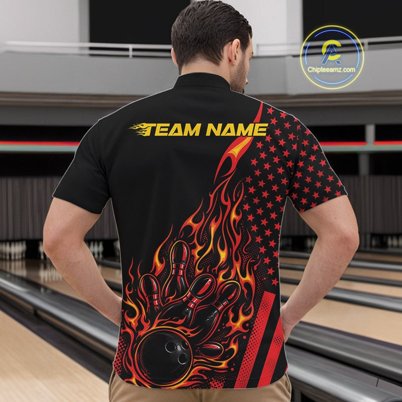 Front view of a male model in a bowling alley wearing a black quarter-zip shirt featuring a red-orange flaming bowling strike design with patriotic accents.