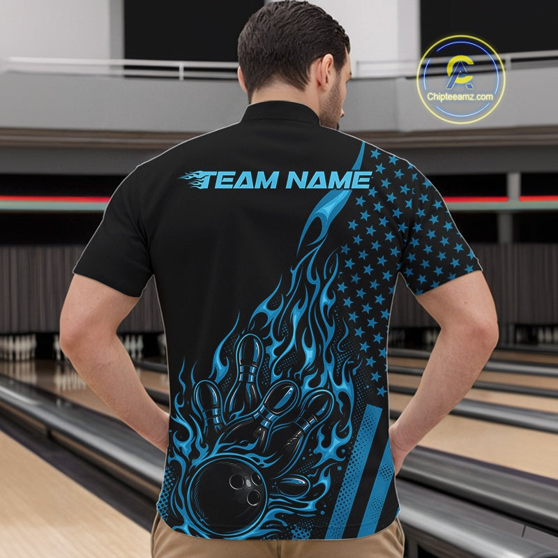 Front view of a male model in a bowling alley wearing a black quarter-zip shirt featuring a blue flaming bowling ball knocking down pins.