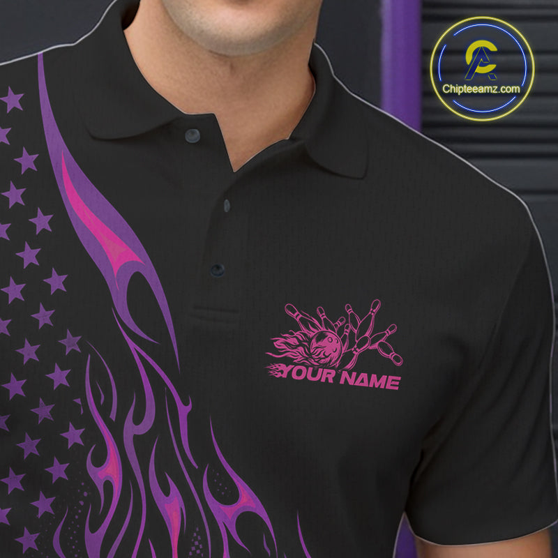 Close-up of the left chest on a black bowling polo shirt featuring a pink and purple flaming bowling ball striking pins with patriotic styling.