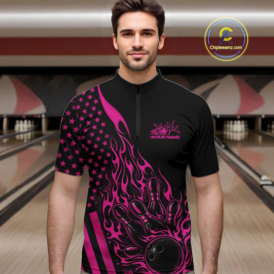 Male model wearing a black bowling quarter-zip shirt at a bowling lane with pink flame bowling strike artwork and patriotic accents.