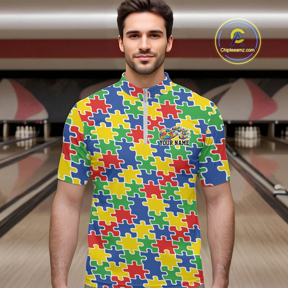 Male model in a bowling lane wearing a multicolored quarter-zip shirt, seamless puzzle pattern design in red, blue, green, and yellow tones.
