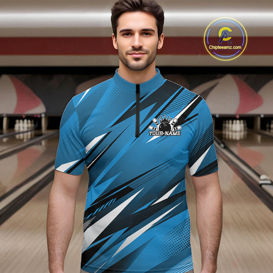 Man wearing a blue bowling shirt with a logo in a bowling alley.