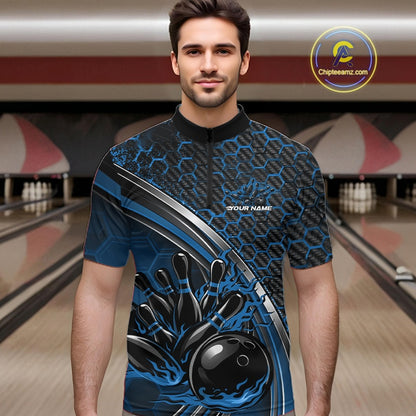 Male model in a bowling lane wearing a black and blue quarter zip shirt with honeycomb texture and a flaming bowling ball hitting pins graphic.