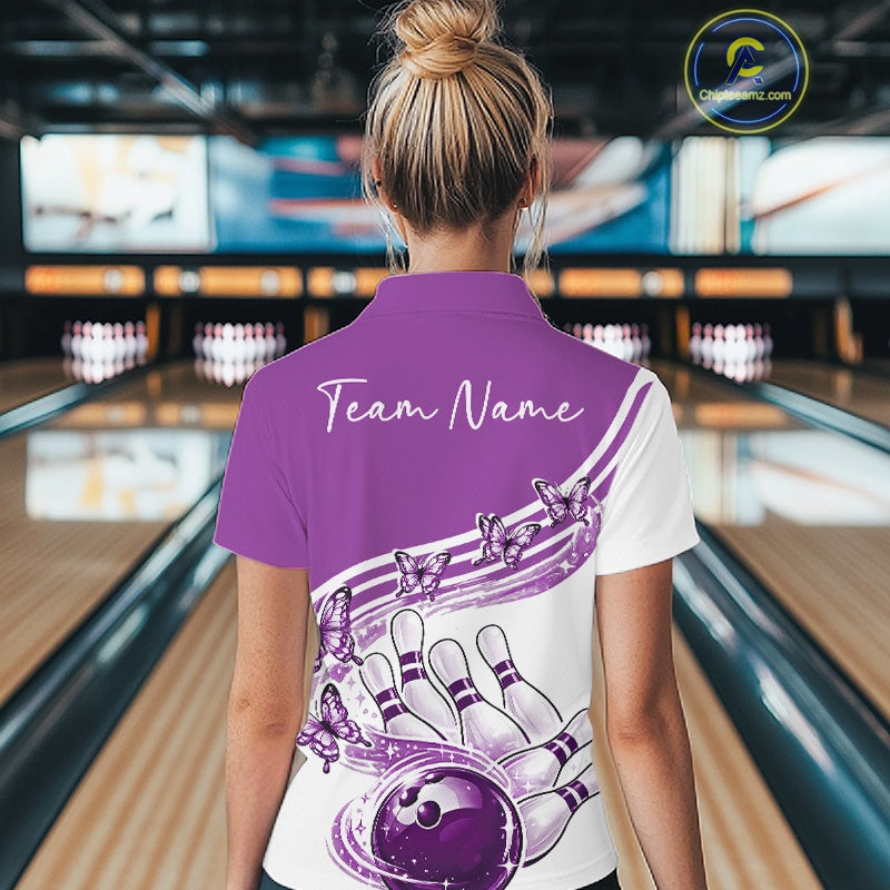 Back view of a female model in a white and purple bowling quarter zip with butterfly artwork and bowling graphics at the bowling lane