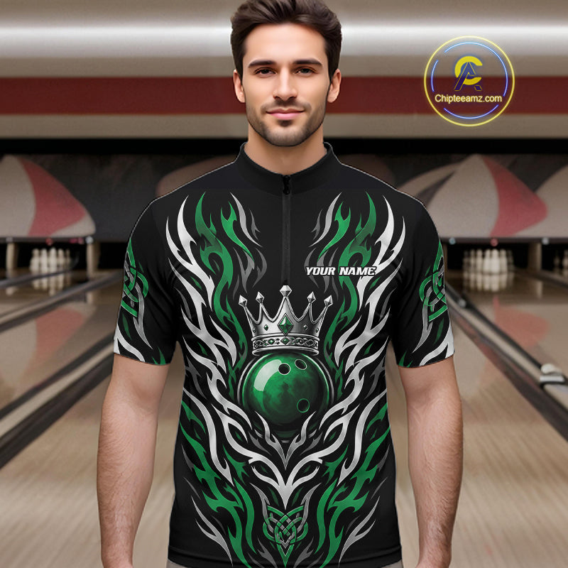 A man wearing a black short-sleeve quarter zip shirt with a green and white tribal flame design, a crown graphic, and a green bowling ball motif. The jersey has 'YOUR NAME' printed on the chest.