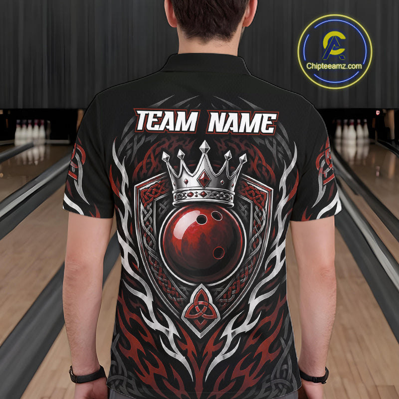 A man viewed from behind wearing a black short-sleeve bowling polo shirt with a large graphic design featuring a crown, red crowned bowling ball, shield, and the text 'TEAM NAME'. Bowling lanes are visible in the background