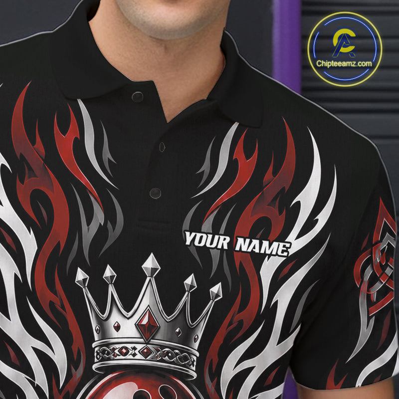 A close-up of a black short-sleeve polo shirt worn by a model, featuring a graphic design with red and white flames, a silver crown, and the text 'YOUR NAME' on the chest. 