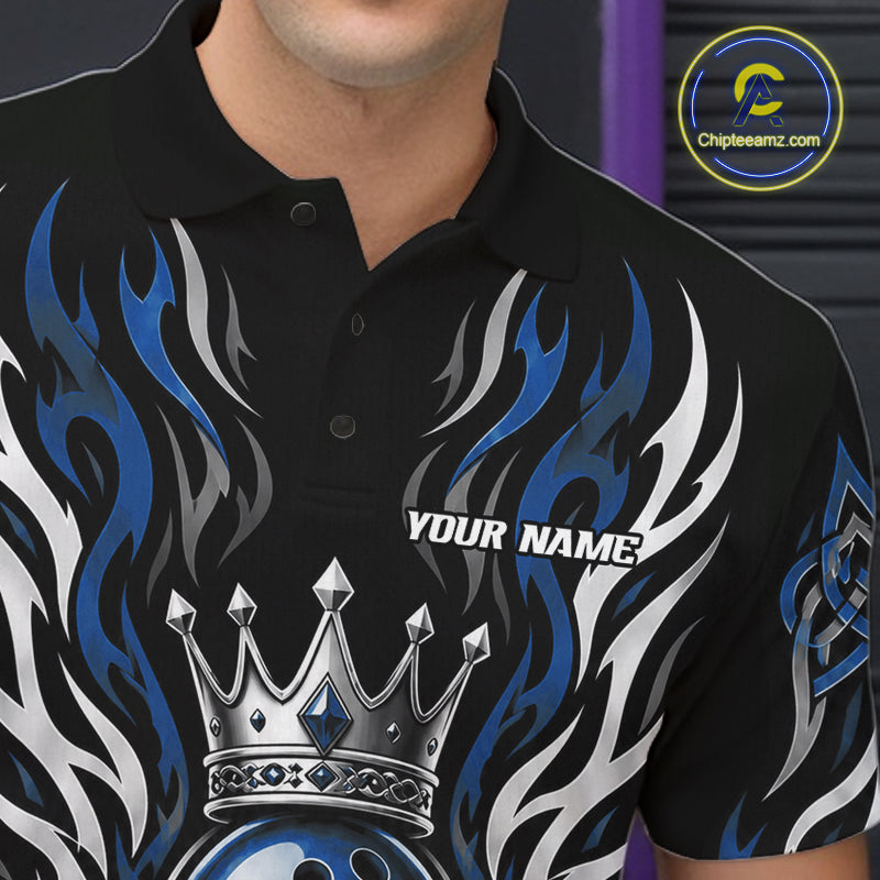 A close-up of a man wearing a black short-sleeve polo shirt with a blue, white, and silver flame graphic design, a silver crown motif, and the text 'YOUR NAME' on the chest. 