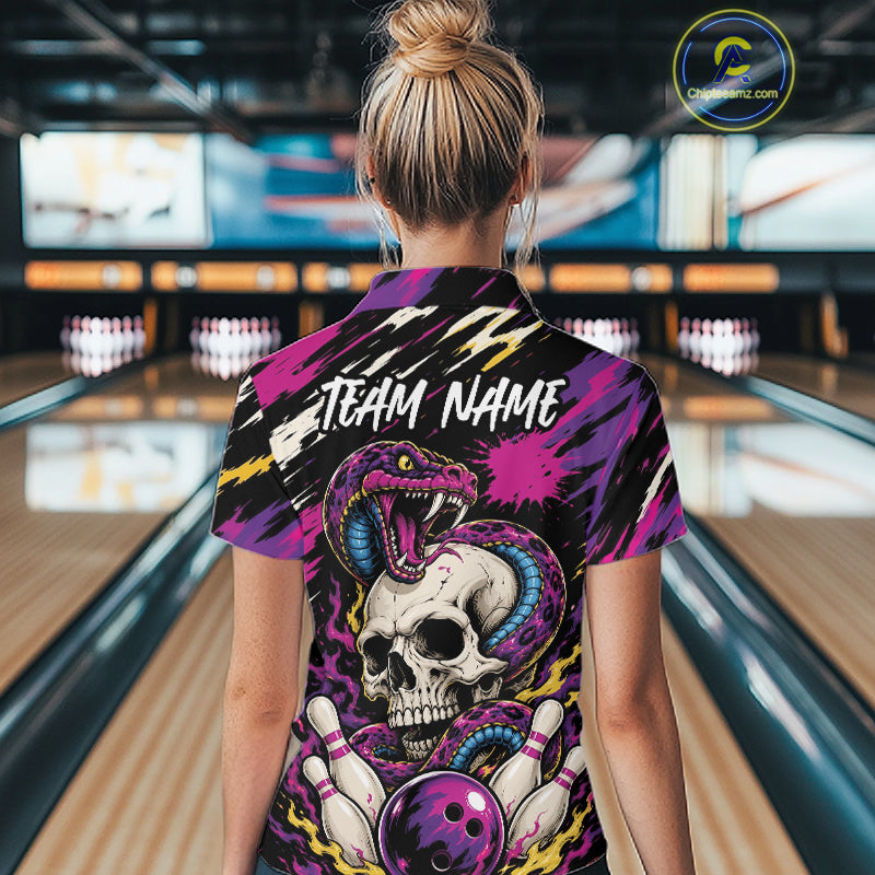 A woman viewed from behind wearing a short-sleeve bowling shirt with a bold graphic print featuring a skull, snake, bowling pins, and lightning bolts. The shirt has the text 'TEAM NAME' printed across the upper back.