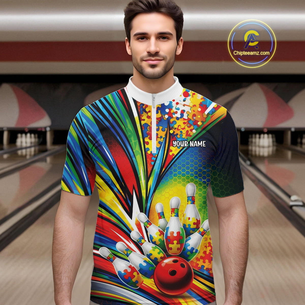 In A Bowling Lane, Front View Male Model Wearing Quarter-Zip Shirt Showcasing Colorful Autism-Themed Bowling Strike Illustration With Vibrant Puzzle Graphics