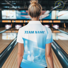 Load image into Gallery viewer, Back view of a female model in a bowling lane wearing a white and blue quarter zip shirt with bowling ball and pins over a pink geometric background.