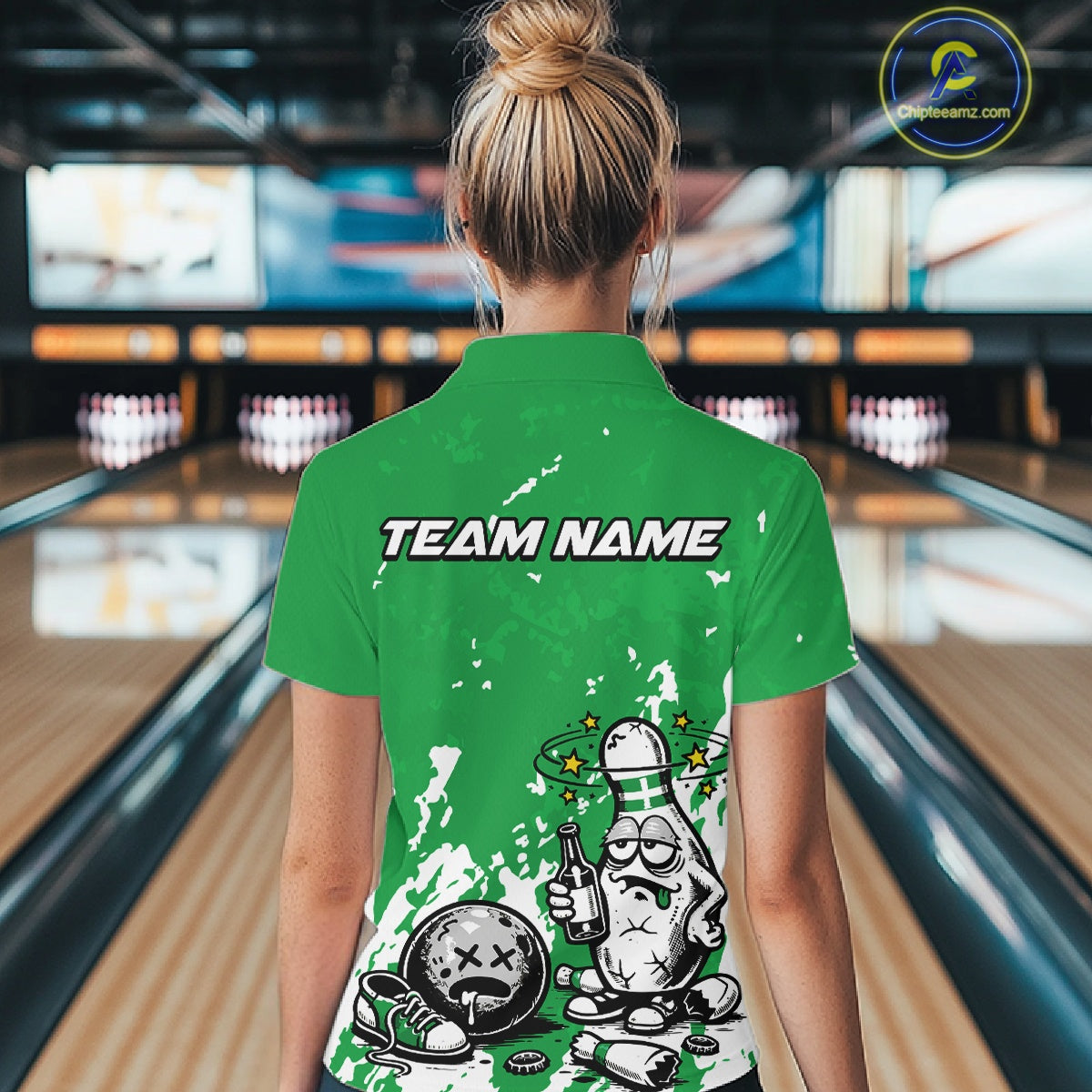 Back view female model wearing green and white quarter zip bowling shirt in bowling lane, humorous bowling pin with beer bottle artwork
