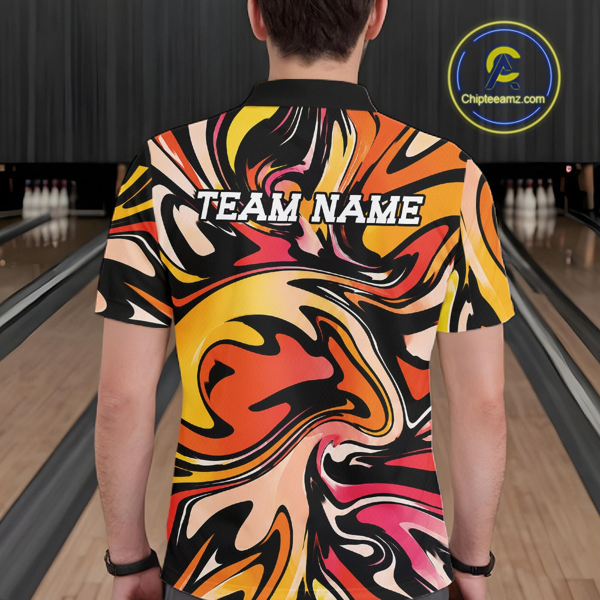 Person wearing a colorful bowling shirt with 'TEAM NAME' text in a bowling alley.