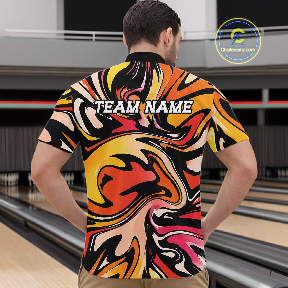 Man wearing a colorful bowling shirt with 'TEAM NAME' text in a bowling alley.