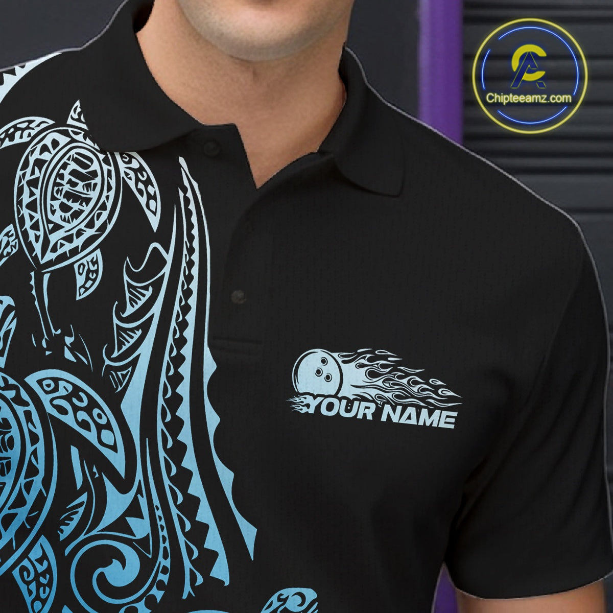 Left chest close-up of a black and blue bowling polo shirt displaying Polynesian bowling motifs and swirl accents.