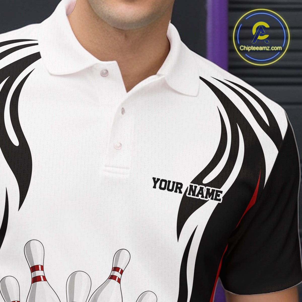Close-up of the left chest on a white, black, and red bowling polo shirt featuring bowling ball and pins graphics.