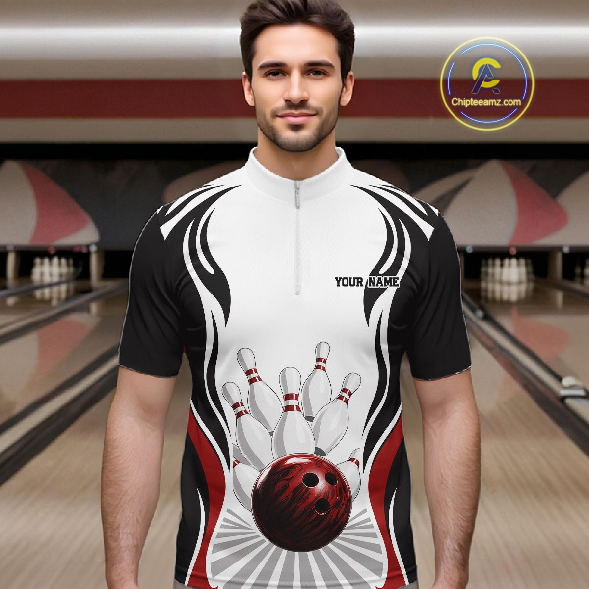 Front view of a male model at the bowling lane wearing a white, black, and red bowling quarter-zip shirt with bowling ball and pins graphics.