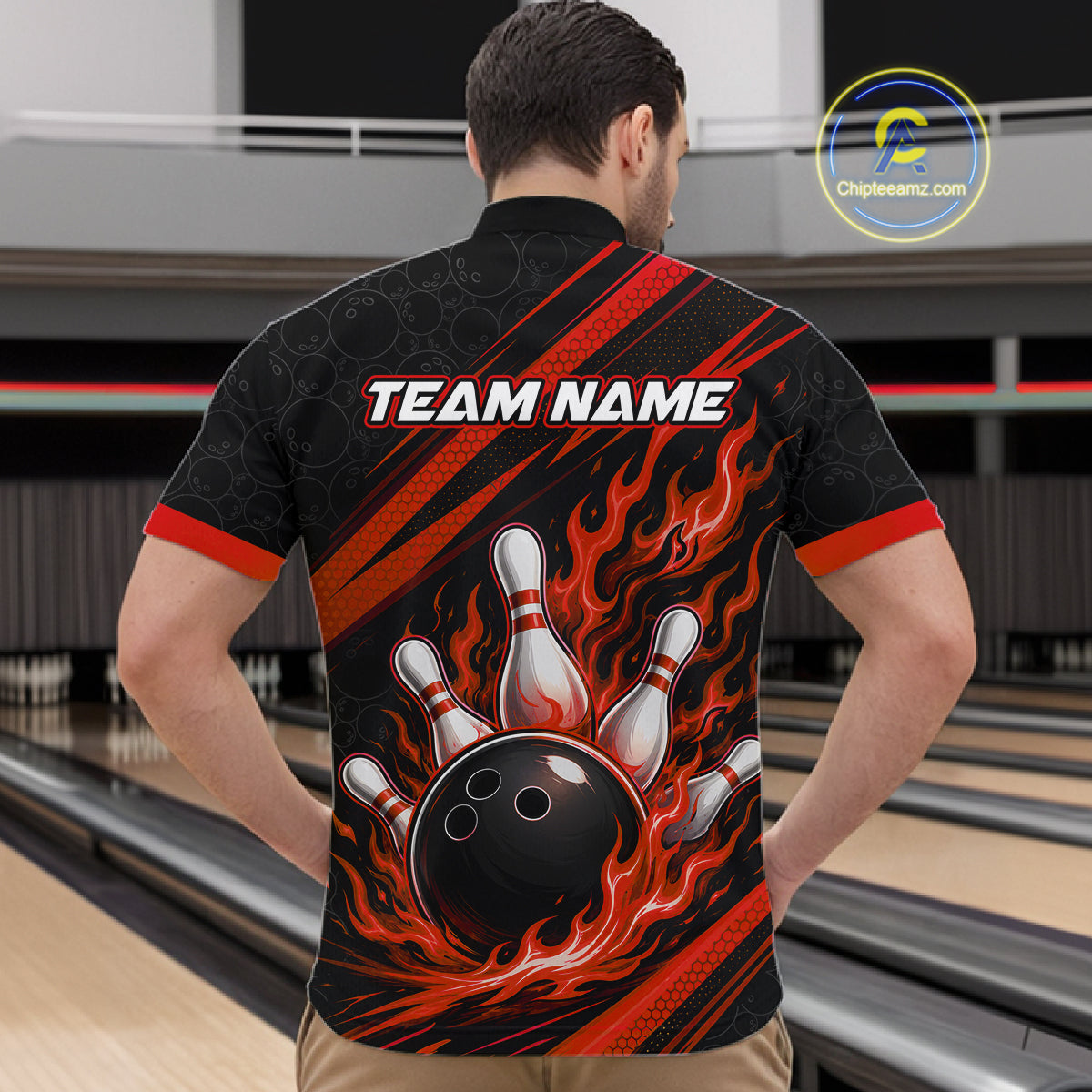 A man viewed from behind wearing a black bowling-themed short-sleeve quarter zip shirt with red and orange flame graphics, a bowling ball and pins design on the back, and 'TEAM NAME' 
