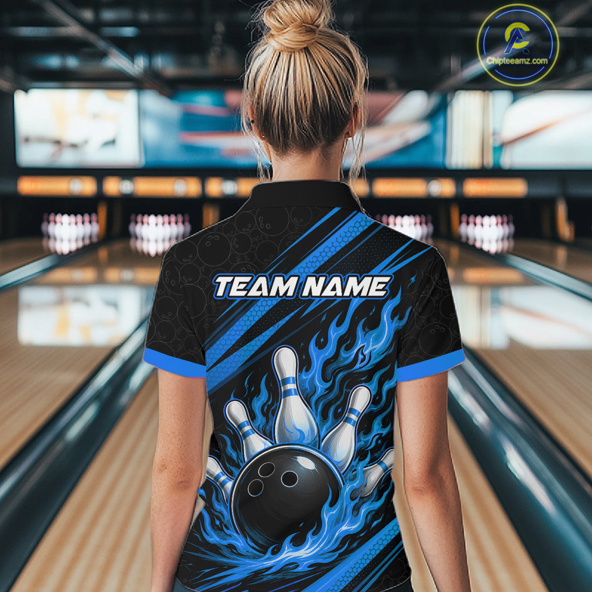 A woman viewed from behind wearing a custom bowling-themed short-sleeve polo shirt with a black, blue, and white flame graphic and 'TEAM NAME' 