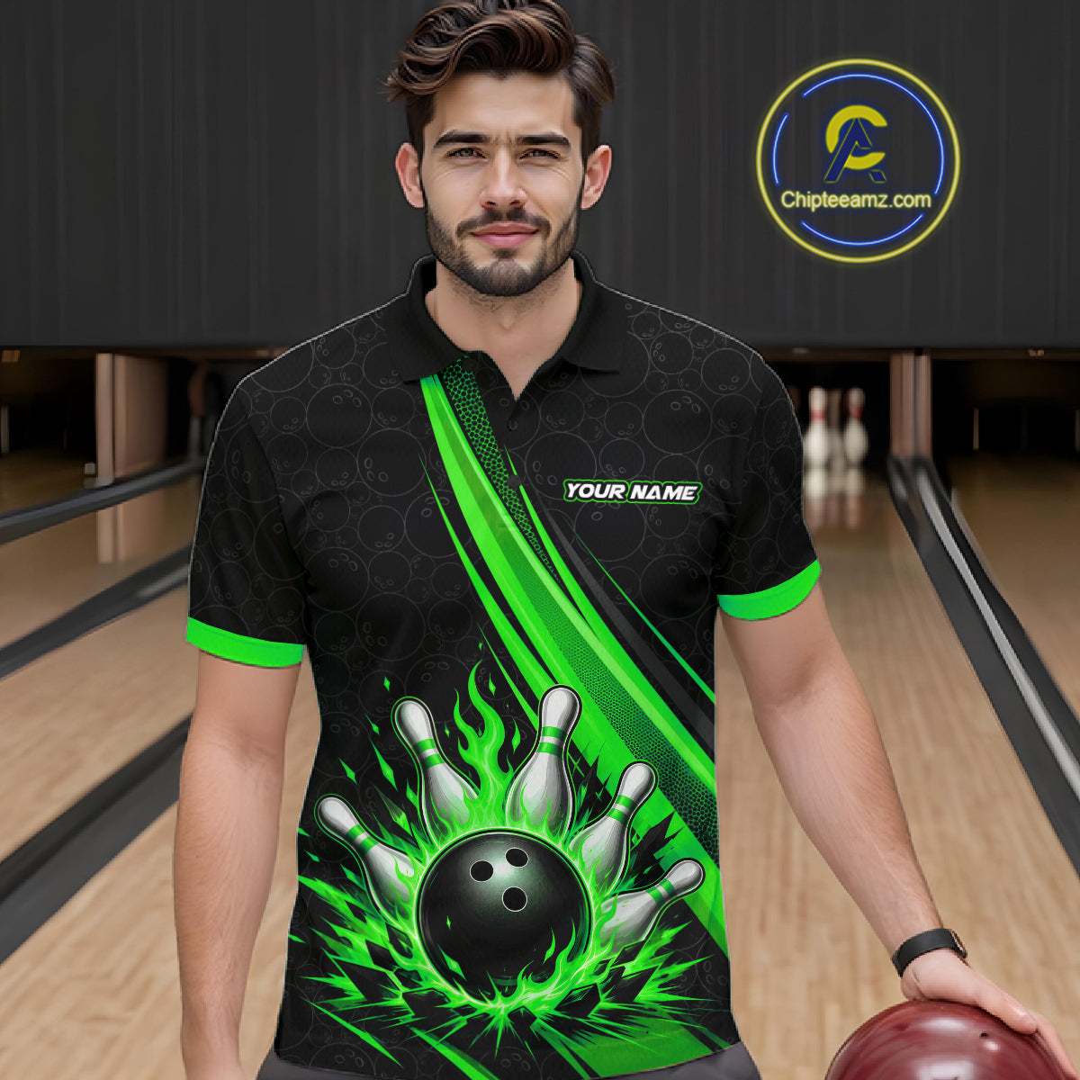 A man wearing a black short-sleeve bowling-themed polo shirt with bright green flame and bowling pin graphics, standing in a bowling alley. The shirt features a black bowling ball and pins design on the front with green accents.