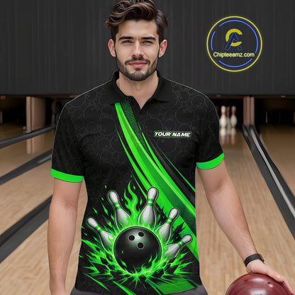 A man wearing a black short-sleeve bowling-themed polo shirt with bright green flame and bowling pin graphics, standing in a bowling alley. The shirt features a black bowling ball and pins design on the front with green accents.