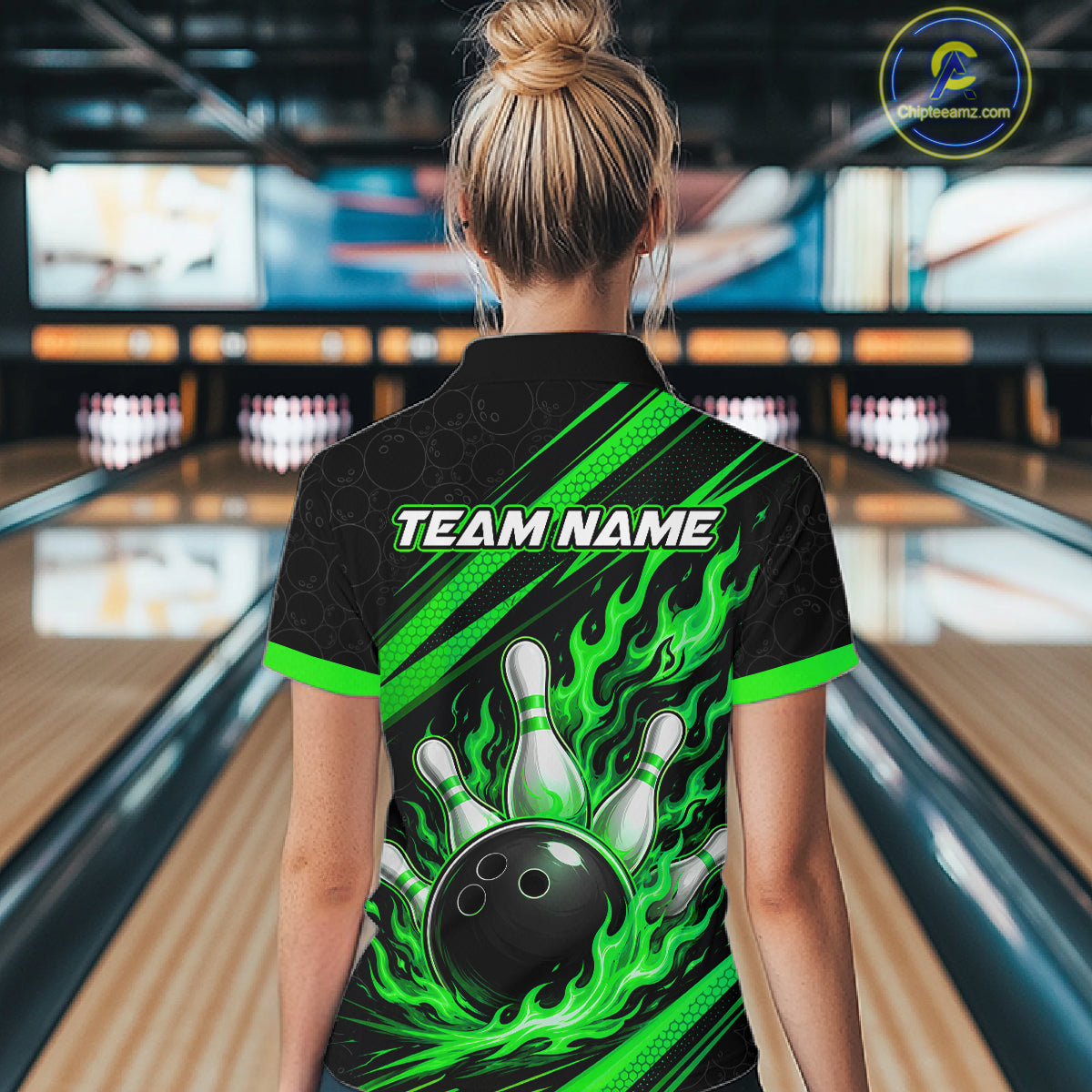 A woman viewed from behind wearing a black short-sleeve bowling polo shirt with bright green flame graphics, bowling pins, and a bowling ball design on the back, with 'TEAM NAME' printed across the upper back