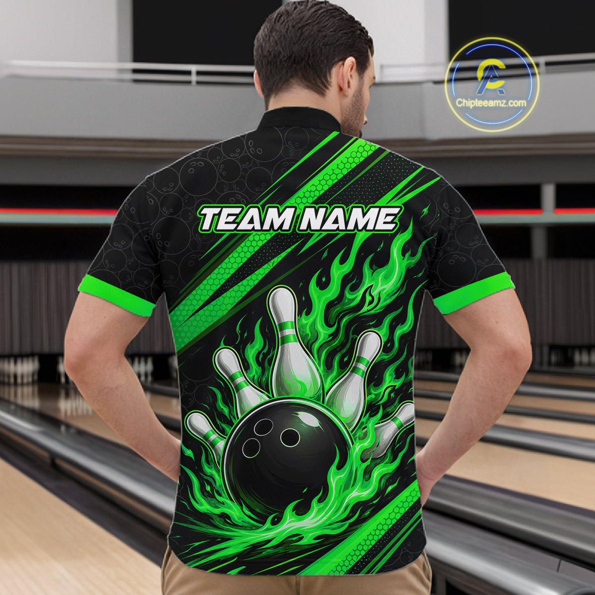 A man viewed from behind wearing a black bowling-themed short-sleeve quarter zip shirt with bright green flame and diagonal stripe graphics, white bowling pins, and a black bowling ball on the back. The shirt has 'TEAM NAME' printed across the upper back.