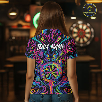 A person viewed from behind wearing a short-sleeve shirt with a vivid psychedelic neon pattern in purple, blue, green, yellow, and pink. The shirt has 'TEAM NAME' printed across the upper back and a dartboard graphic near the lower back.