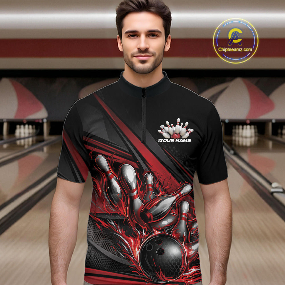 Male model in a bowling lane wearing a black quarter-zip shirt, red flame bowling ball hitting pins with energetic abstract stripe design.