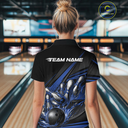 Back view of a female bowler wearing a black quarter-zip shirt, blue flame bowling strike design with geometric stripe accents.