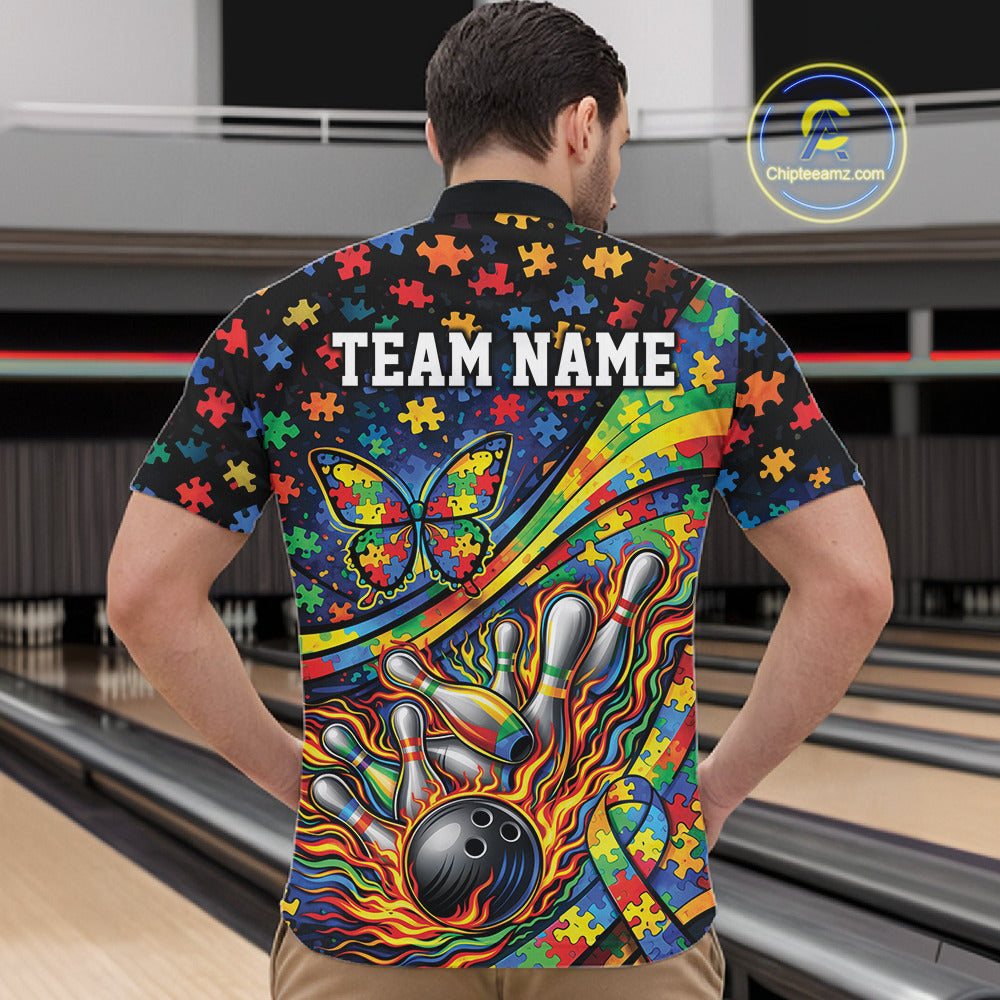 Male model in a bowling lane wearing a colorful quarter-zip shirt, vibrant autism-themed bowling artwork with ribbon, butterfly, and strike elements.