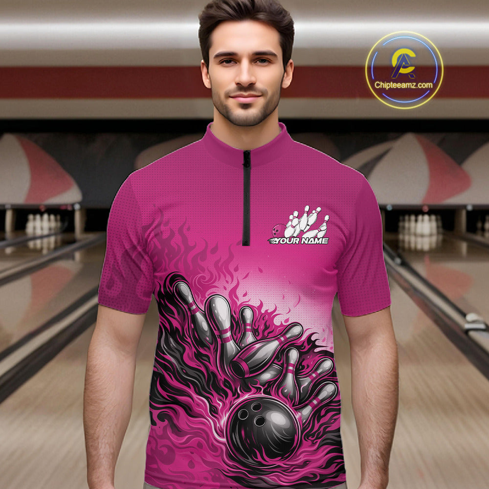Male model in a bowling lane wearing a pink quarter-zip shirt, flame bowling ball hitting pins with vibrant motion graphics.
