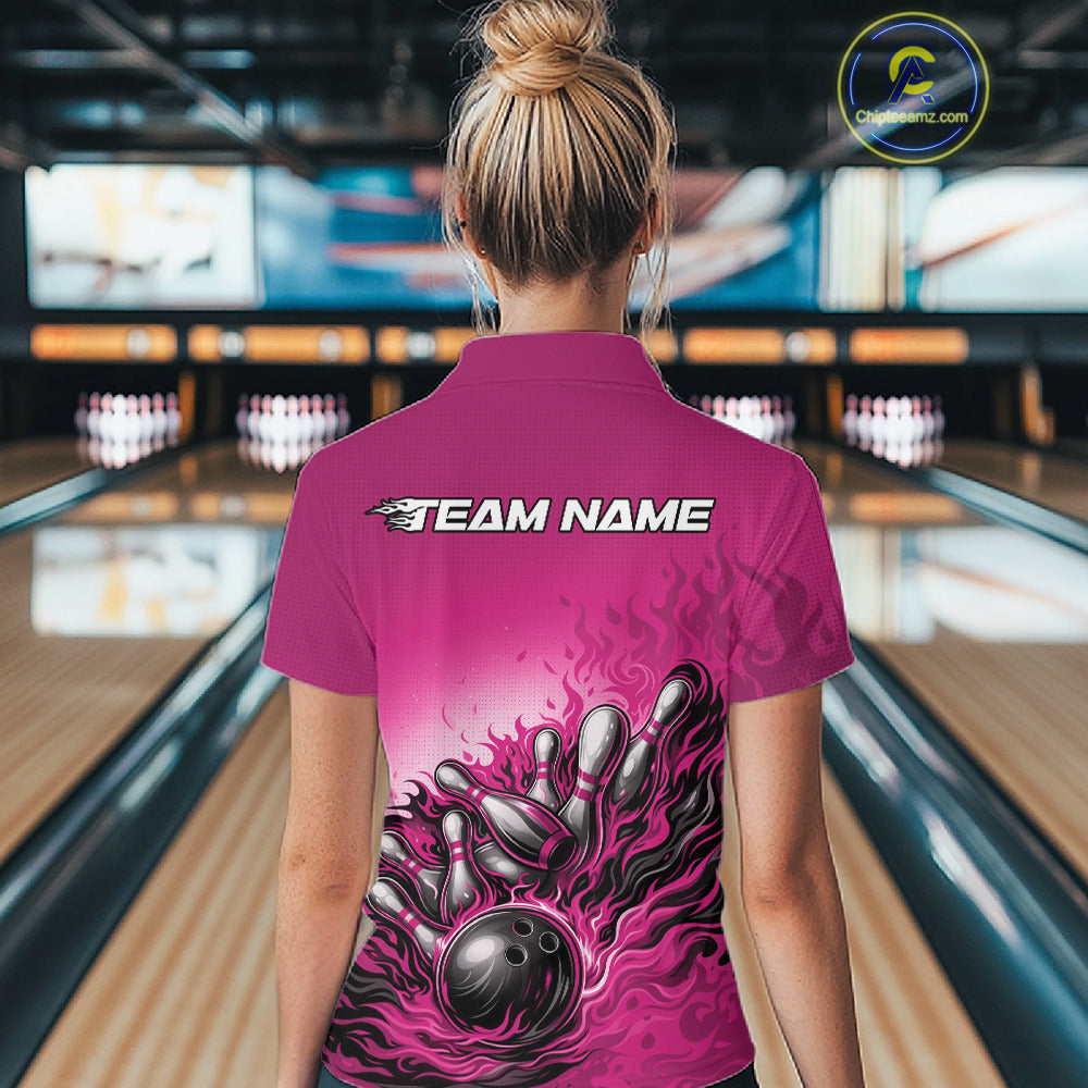 Back view of a female bowler wearing a pink quarter-zip shirt, flame bowling ball and pins design with bold action-style artwork.