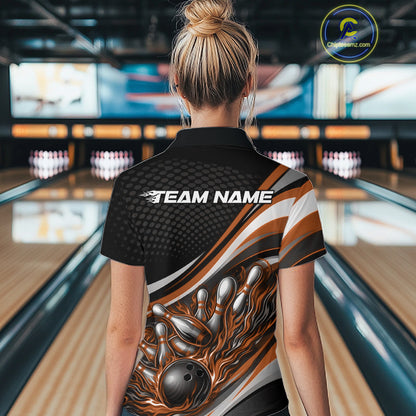 Back view of a female bowler wearing a black and orange polo shirt, flame bowling ball hitting pins with bold action graphics.