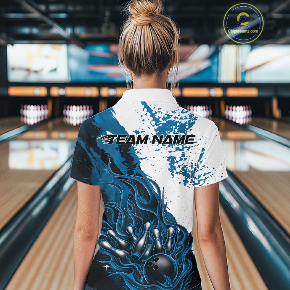 Back view of a female model in a bowling lane wearing a black quarter-zip shirt featuring blue and white flame bowling ball and pins design with bold athletic styling.