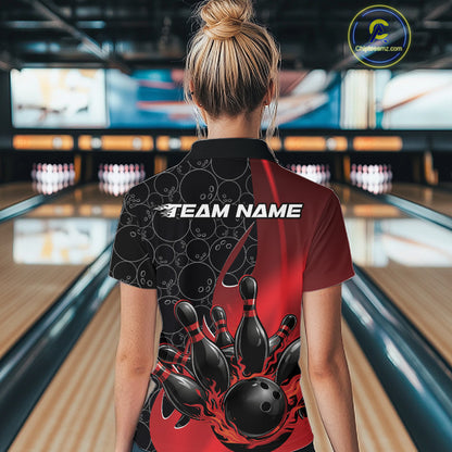 Back view of a female model in a bowling lane wearing a black and red polo shirt featuring flaming black bowling ball striking pins with energetic bowling graphics.