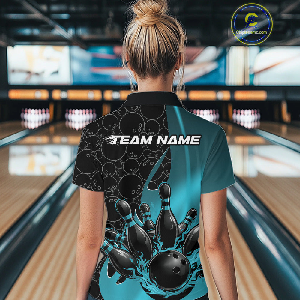 Back view of a female model in a black and blue bowling quarter-zip shirt inside a bowling lane, showcasing flaming bowling ball hitting pins illustration with gradient bowling ball motif.