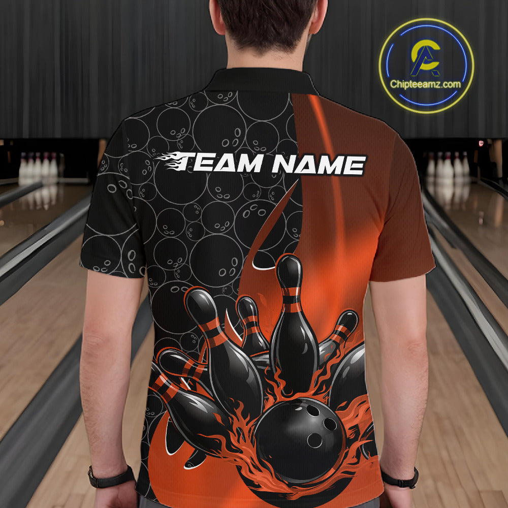 Back view of a male model in a bowling lane wearing a black and orange polo shirt featuring flaming black bowling ball striking pins with bold bowling action graphics.