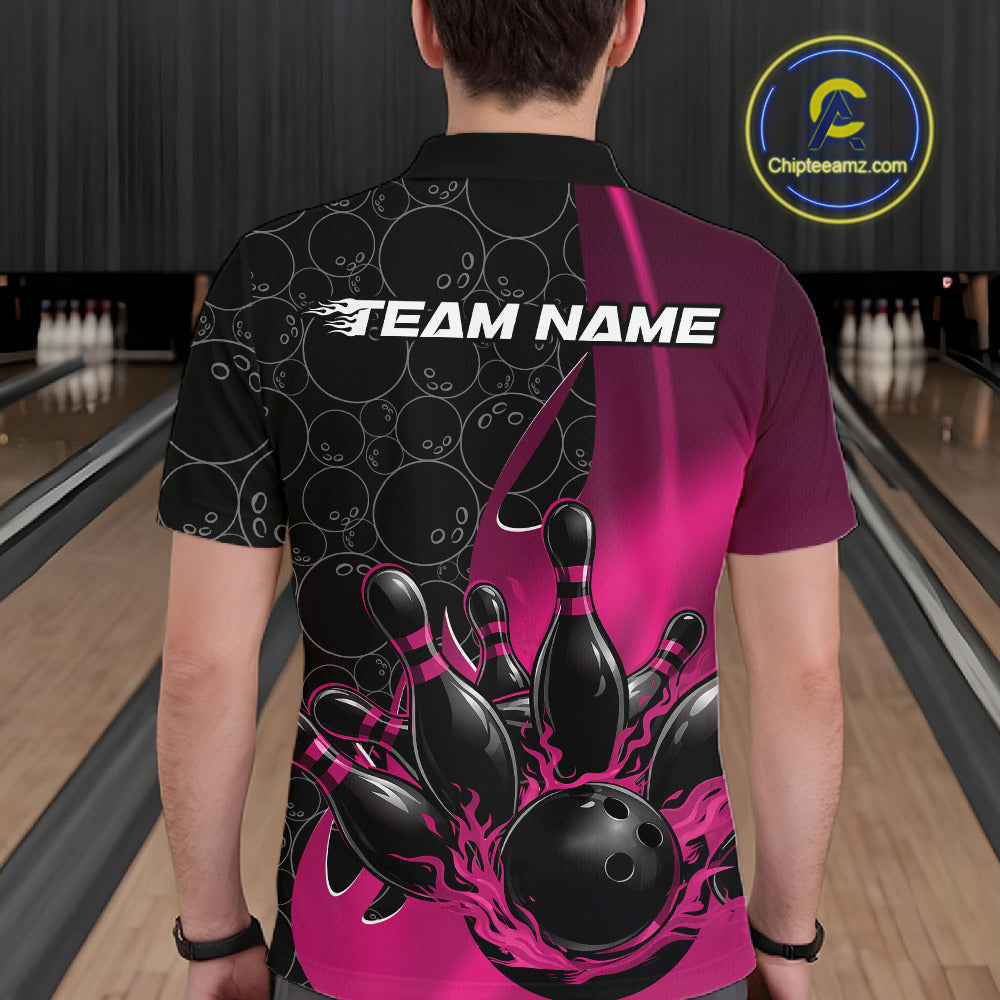 Back view of a male model in a bowling lane wearing a black and pink polo shirt featuring flaming black bowling ball striking pins with athletic sports styling.