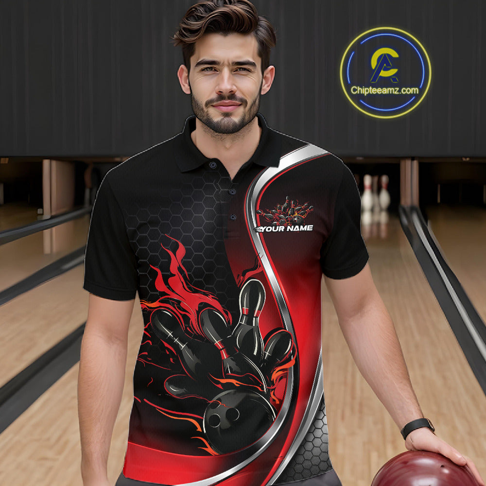 Male model seen from the front in a bowling lane wearing a black and red polo shirt featuring a flame bowling ball striking pins in an energetic action scene.