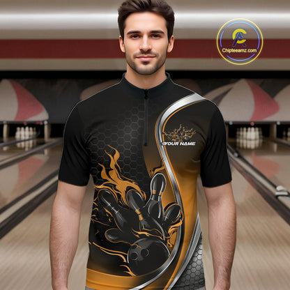 Male model front view inside bowling center wearing black and yellow quarter zip shirt featuring flaming bowling ball hitting pins graphics
