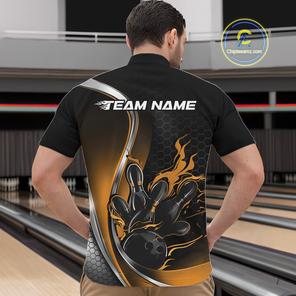 Male model front view at bowling lane wearing black and yellow quarter zip shirt with flame bowling action themed illustration