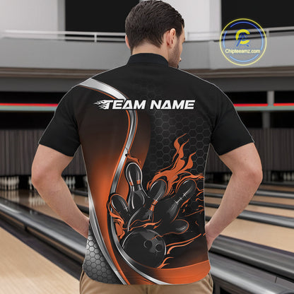 Male model front view at bowling lane wearing black and orange quarter zip shirt with flame bowling strike illustration and energetic design
