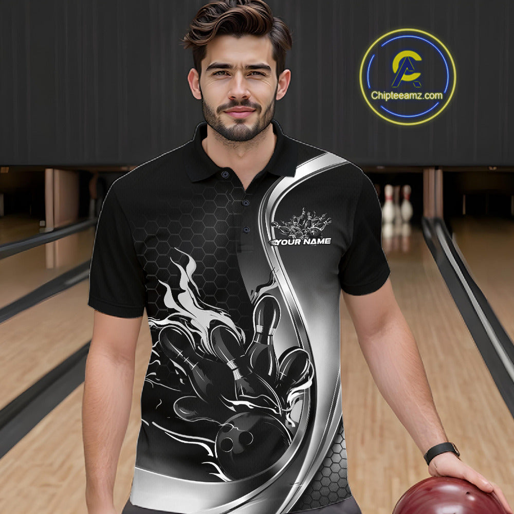 Male model seen from the front in a bowling lane wearing a black and gray polo shirt featuring a flame bowling ball and pins design in a dynamic sports scene.