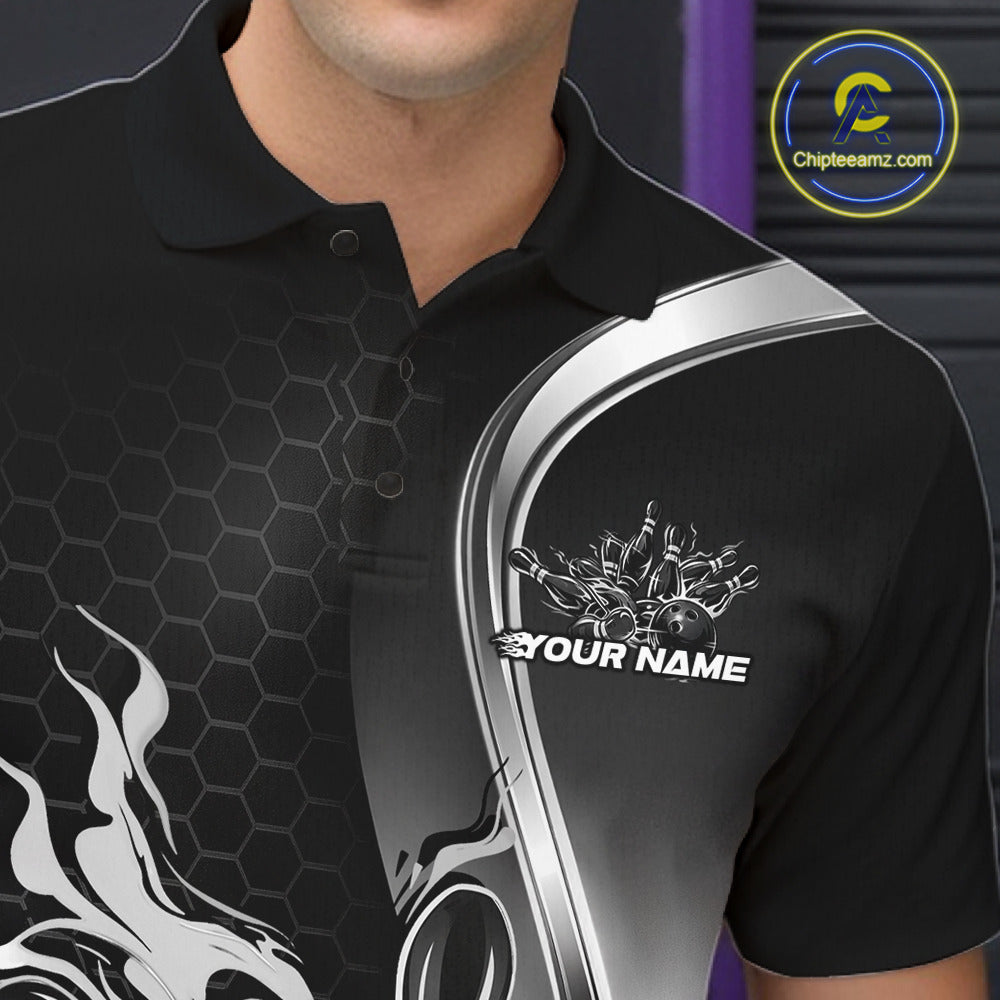 Close-up view of the left chest area of a black and gray bowling polo shirt showing a flame bowling ball and pins design detail.